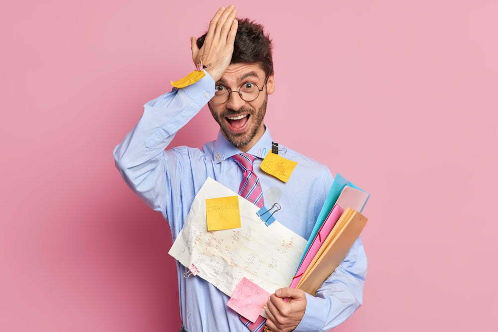 Forgetful student remember about one more task before exam keeps hand on forehead poses with papers tries to learn all formulas makes memo notes to keep everything in mind. Studying concept. Forgetful Teacher